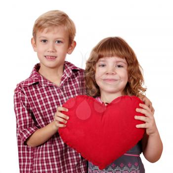 little girl and boy posing with red heart
