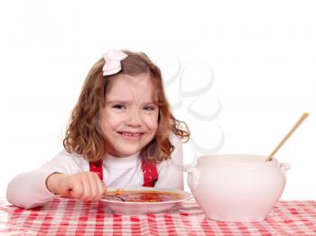 happy little girl eat tomato soup