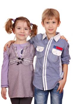 little girl and boy posing on white