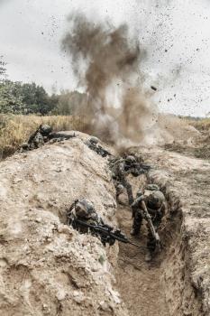 Squad of elite french paratroopers of 1st Marine Infantry Parachute Regiment RPIMA in action in enemy trenches, militants and machine gunner