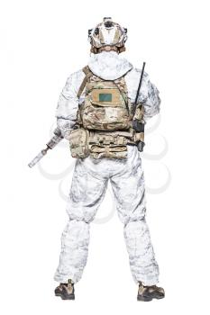 Special forces operator of Navy Seals armed with assault rifle with closed face in polarized sunglasses and military winter camo clothes designed to operations in extreme conditions. Studio shot
