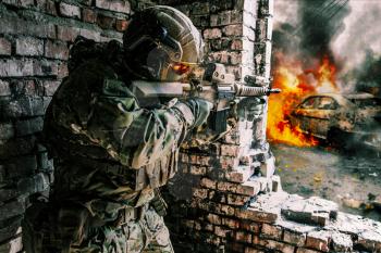 Army soldier in action in ruined building