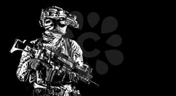 Half length portrait of army special forces rifleman, commando elite soldier equipped radio tactical headset, armed service rifle, using night vision goggles in darkness, isolated on black, copyspace