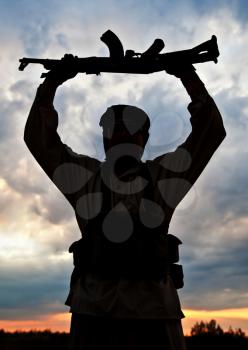 Silhouette of muslim militant with rifle
