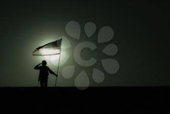 Silhouette of American army soldier, Marines rifleman saluting and holding waving on wind national flag on background of night sky with moon backlight. Heroism and patriotism, military honor concept