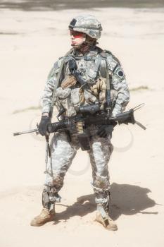 Portrait of United states airborne infantry machinegunner, camo uniforms dress. Combat helmet ammo, front view, full body