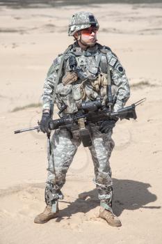Portrait of United states airborne infantry machinegunner, camo uniforms dress. Combat helmet ammo, front view