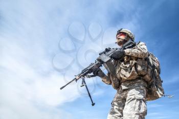 Portrait of United states airborne infantry machinegunner, camo uniforms dress. Combat helmet low angle