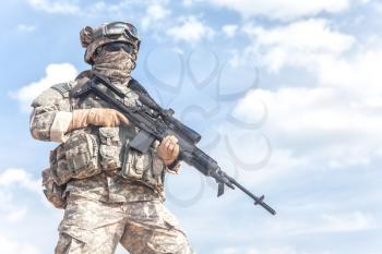 Portrait of United states airborne infantry marksman with arms, camo uniforms dress. Combat helmet on, face mask, cropped
