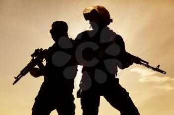 Silhouette of special forces operators with weapons