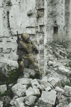 Post apocalypse. Sole survivor in tatters and gas mask on the ruins of the destroyed city