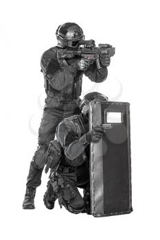 Team of swat police special forces aiming criminals with pistol and rifle hiding behind ballistic shield. Isolated on white full body portrait