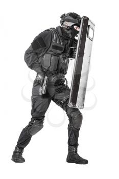 Studio shot of swat police special forces with pistol hiding behind ballistic shield moving treading. Isolated on white full body portrait