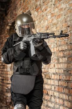 Special forces operator in black uniform and bulletproof 