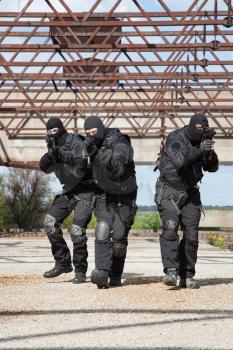 Special forces operators in black uniform in action