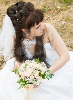 Bride with a bunch of flowers, in a wedding dress