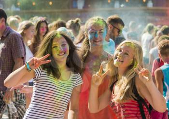 Lviv, Ukraine - August 30, 2015: Girls have fun during the festival of color in a city park in Lviv.