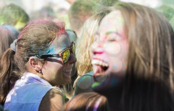 Lviv, Ukraine - August 30, 2015: Girl with glases  have fun during the festival of color in a city park in Lviv.