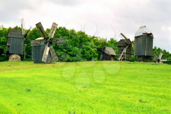 Wooden mills on the field of green grass. Kiev, Ukraine.

