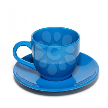 Blue ceramic cup and saucer isolated on white.