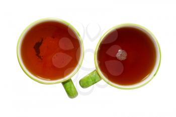 Two teacups with tea isolated on white.