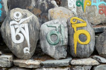 Tibetan colorful prayer stones with letters. Nepal.