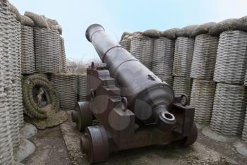 Retro black melal gun in the fortification