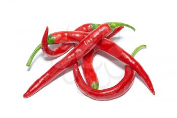 Stack of red hot chili peppers isolated on white