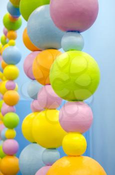 Colored balls of different sizes. Strings of bead. Abstract background.