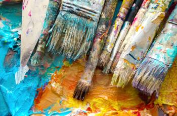 Artist paint brushes and palette. Old brushes. Close up.