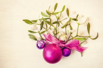 New Years and Christmas decorations with mistletoe on wooden background. Nature background.