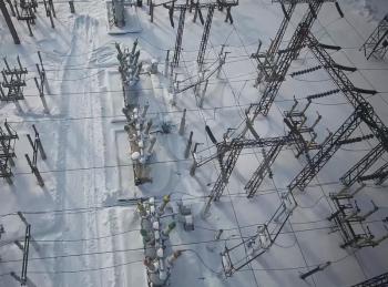 Electrical substation in the snow in winter. High voltage wires