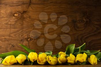 Spring tulips bouquet on wooden background, copy space. Flowers greeting. Flowers postcard. Spring flowers