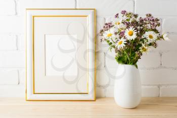 Frame mockup with wild flowers bouquet. Portrait or poster white frame mockup. Empty white frame mockup for presentation artwork.