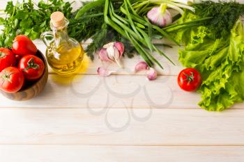Summer vegetables and olive oil background, place for text. Ripe vegetables. Fresh vegetables. Healthy eating concept. Vegetarian food. Healthy eating. 