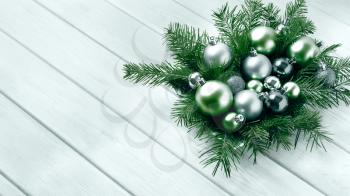 Christmas table centerpiece with silver and green ornaments. Christmas party decoration with shiny balls. Christmas greeting background. Copy space.