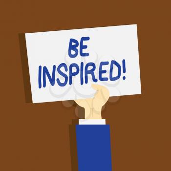 Writing note showing Be Inspired. Business concept for fill someone with urge or ability to do or feel something Clipart of Hand Holding Up Sheet of Paper on Pastel Backdrop