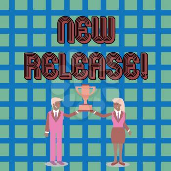 Text sign showing New Release. Business photo text announcing something newsworthy recent product or service Man and Woman in Business Suit Holding Together the Championship Trophy Cup