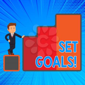 Handwriting text writing Set Goals. Conceptual photo process of identifying something that you want to accomplish Happy Businessman Presenting Growth and Success in Rising Bar Graph Columns