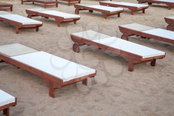 A relaxing beds fix in the sand. A flat structure filled with comfy fabric attracting tourist for body massage. Wellness therapy ideas for beach goers