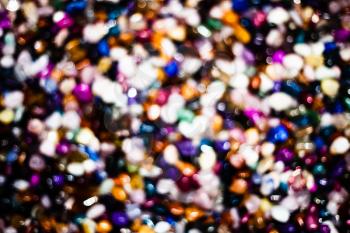 Colorful background with small stones. Abstract blurred background with colored rocks. Closeup image of decorative stones. Shiny precious small stones background.