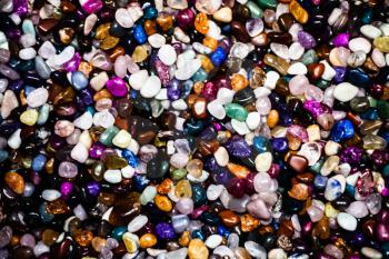 Group of many different natural gemstones. Collection of small colored semiprecious gemstones amethyst, lapis lazuli, rose quartz, citrine, ruby, amazonite, moonstone, labradorite, chalcedony