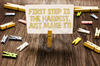 Text sign showing First Step Is The Hardest, Just Make It. Conceptual photo dont give up on final route Clothespin holding white paper note several clothespins wooden floor