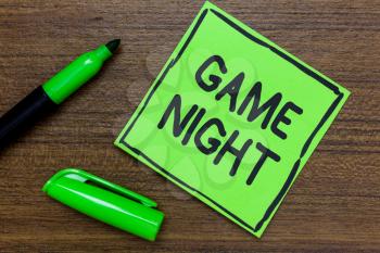 Conceptual hand writing showing Game Night. Business photo showcasing event in which folks get together for the purpose of getting laid Green Paper Communicate ideas Marker Wooden background