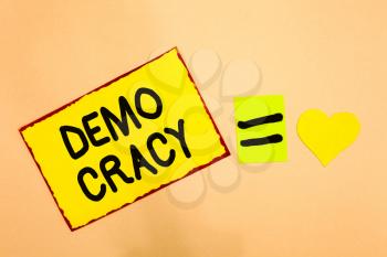 Conceptual hand writing showing Demo Cracy. Business photo text freedom of the people to express their feelings and beliefs Yellow paper reminder equal sign heart sending romantic feelings