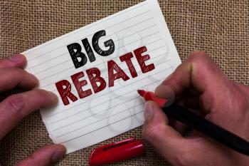 Writing note showing Big Rebate. Business photo showcasing Huge rewards that can get when you engaged to a special promo Man's hand hold white paper with symbolic letter jute sack background