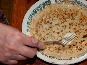 Pancakes on a new cast-iron skillet on Shrovetide