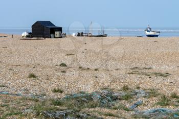 Old shack and boats on Dungeness beach