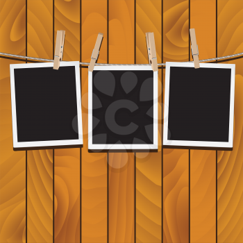 Retro photo frames hung on a rope with wooden clothespins.