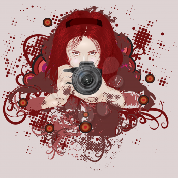 Red haired girl photographer with camera in hands on grunge background.